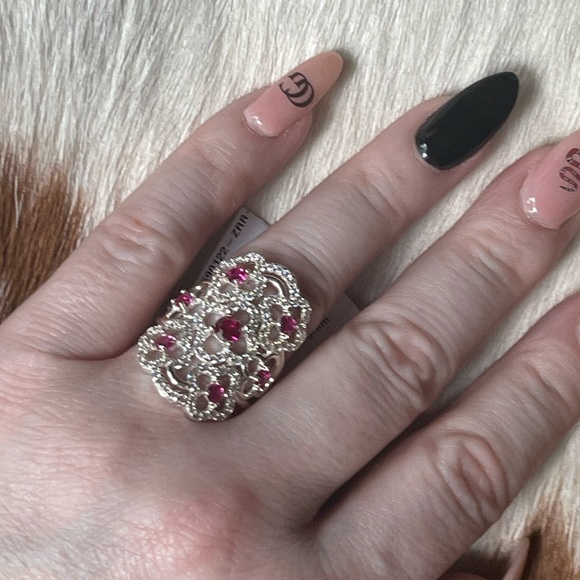 Long clover ring with simulated diamonds and rubies set in sterling silver